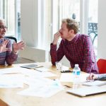 Coworkers discussing at conference table