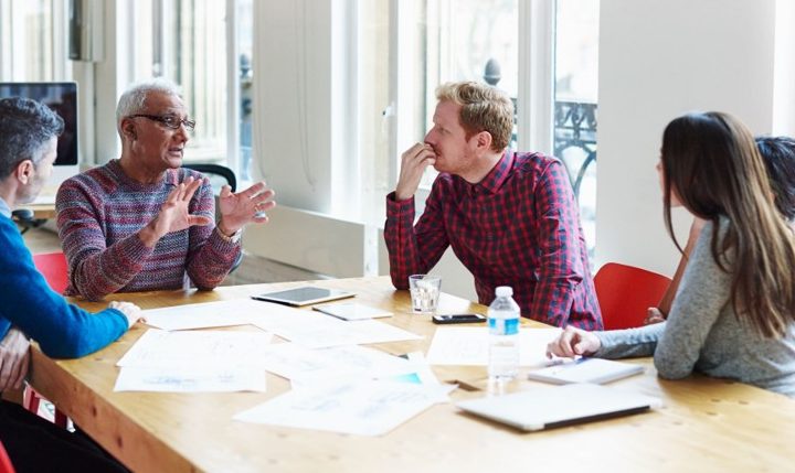 Coworkers discussing at conference table