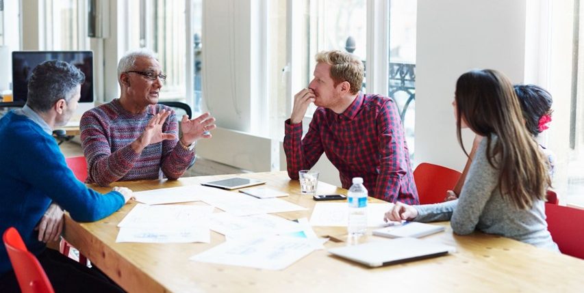 Coworkers discussing at conference table